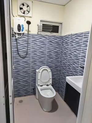 a bathroom with a toilet and a sink at Qalsharyna Chalet inn in Simpang