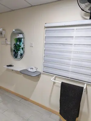 a room with a window with a mirror and a mirror at Qalsharyna Chalet inn in Simpang