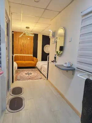 a living room with a couch and a mirror at Qalsharyna Chalet inn in Simpang