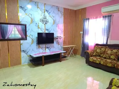 a living room with a couch and a tv at Zai homestay in Kampung Jeram Kawang