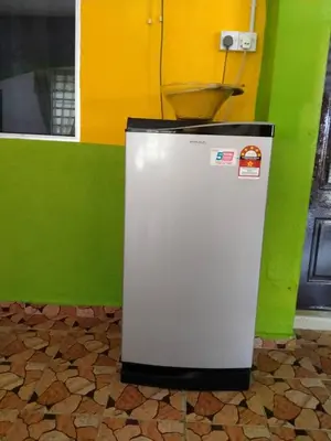 a small refrigerator with a bowl on top of it at Zai homestay in Kampung Jeram Kawang