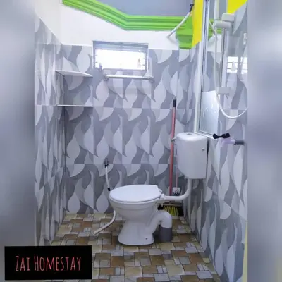 a bathroom with a white toilet in a room at Zai homestay in Kampung Jeram Kawang