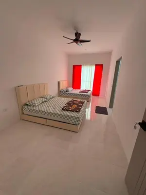 two beds in a room with a ceiling fan at Luxury House Panoramic Views and Elegant Comfort in Batu Gajah