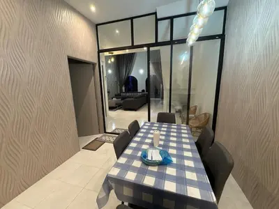 a dining table and chairs in a room with a living room at Luxury House Panoramic Views and Elegant Comfort in Batu Gajah