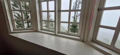 an empty room with three windows with trees at B43A2 Silverpark Resort Best Mountain view Walk up 1 floor in Bukit Fraser