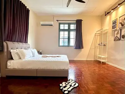 a bedroom with a bed and a wooden floor at Bagan Cozy Family Retreat 4BR 10 Pax in Butterworth