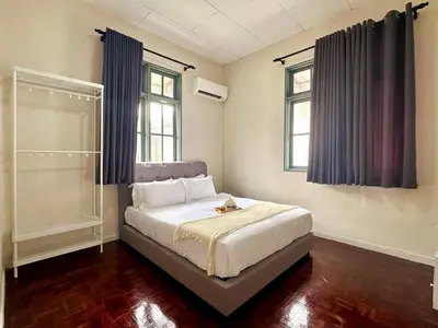 a bedroom with a bed and two windows at Bagan Cozy Family Retreat 4BR 10 Pax in Butterworth
