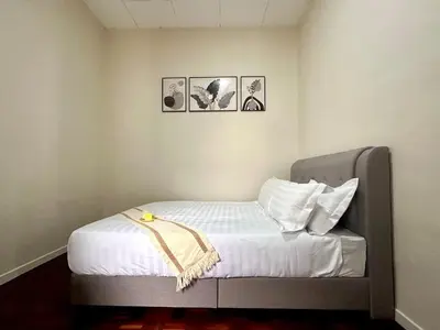 a bed in a room with three pictures on the wall at Bagan Cozy Family Retreat 4BR 10 Pax in Butterworth