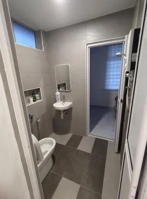 a bathroom with a toilet and a sink at Sweet Home in Balik Pulau