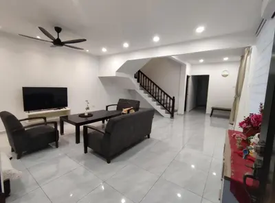 a living room with a couch and a tv at Sweet Home in Balik Pulau