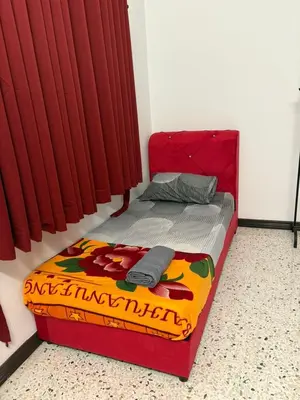 a red bed in a room with red curtains at 786 Bali Top Homestay in Sungai Petani