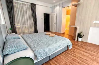 a bedroom with a large bed with two towels on it at 5 Rooms Semi D in Golden Hills - Lena Home in Brinchang