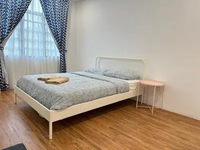a bedroom with a bed and a table and a window at 5 Rooms Semi D in Golden Hills - Lena Home in Brinchang