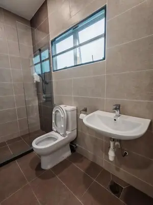 a bathroom with a toilet and a sink and a window at 5 Rooms Semi D in Golden Hills - Lena Home in Brinchang