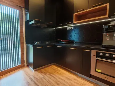 a kitchen with black cabinets and a window at 5 Rooms Semi D in Golden Hills - Lena Home in Brinchang