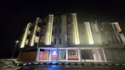 a large white building at night with its lights on at Brick Box Family Hotel Ipoh in Ipoh