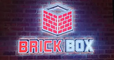 a brick wall with a brick box sign on it at Brick Box Family Hotel Ipoh in Ipoh