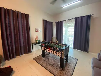a living room with a foosball table in the middle at TheBunga Homestay w Private Pool&Karaoke -Tronoh Perak in Teronoh