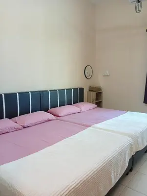 a bed with pink and white sheets in a room at TheBunga Homestay w Private Pool&Karaoke -Tronoh Perak in Teronoh