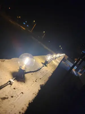 a row of lights in the sand at night at TheBunga Homestay w Private Pool&Karaoke -Tronoh Perak in Teronoh