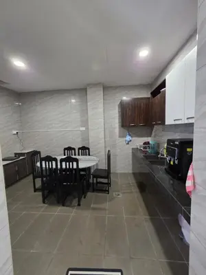 a dining room with a table and chairs in a kitchen at Teeview Homes in Tanah Rata