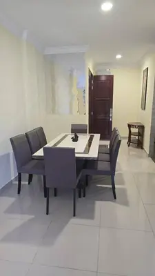 a dining room with a table and chairs at Teeview Homes in Tanah Rata