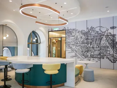 a lobby with a bar with a drawing on the wall at 22 Macalisterz by Mana Mana in George Town