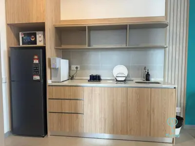 a kitchen with a black refrigerator and a counter at 22 Macalisterz by Mana Mana in George Town