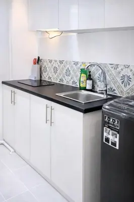 a kitchen with white cabinets and a sink at Anderson Apartment by LUMO LIMA in Ipoh