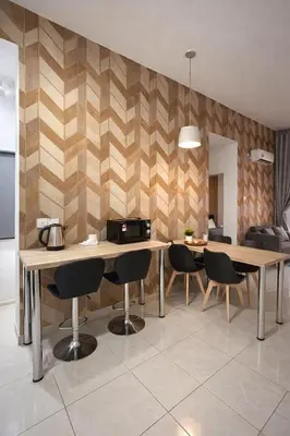 a dining room with two tables and chairs and a kitchen at Anderson Apartment by LUMO LIMA in Ipoh