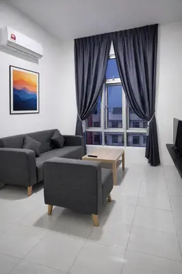 a living room with two couches and a table at Anderson Apartment by LUMO LIMA in Ipoh