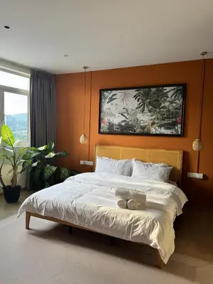 a bedroom with a bed with a teddy bear on it at Penang Stay 2-6px Convenient Free parking in George Town