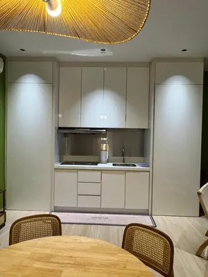 a kitchen with white cabinets and a table with chairs at Penang Stay 2-6px Convenient Free parking in George Town