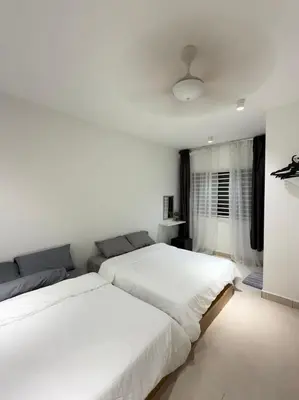 two beds in a bedroom with white walls at Cameron Jaya Homestay 8pax in Tanah Rata