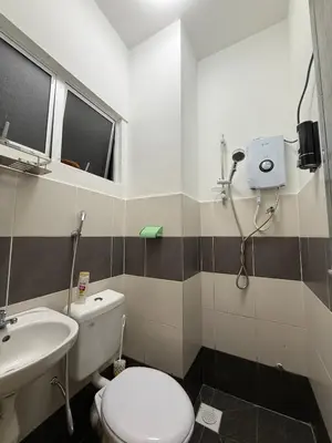 a bathroom with a toilet and a sink at Cameron Jaya Homestay 8pax in Tanah Rata