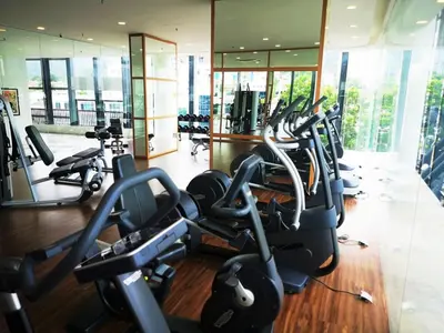 a gym with a bunch of cardio machines at Premier Suite Seaview 3 minute to gurney in Gua Sai