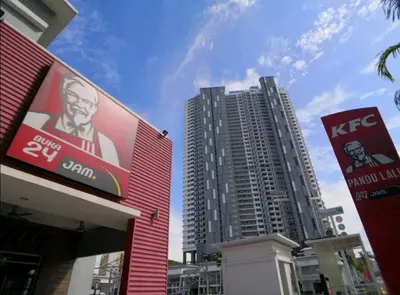 a building with a kfc sign in front of two tall buildings at Premier Suite Seaview 3 minute to gurney in Gua Sai