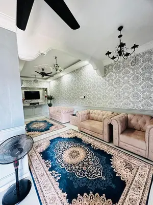 a living room with two couches and a tv at DamaiVistaHomestay in Lumut