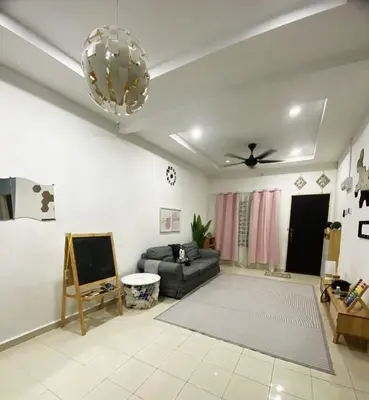 a living room with a couch and a ceiling fan at Teratak Nufal Homestay