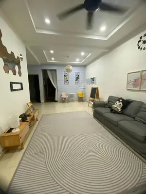 a living room with a couch and a rug at Teratak Nufal Homestay