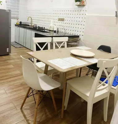 a kitchen with a table and chairs in a kitchen at Teratak Nufal Homestay