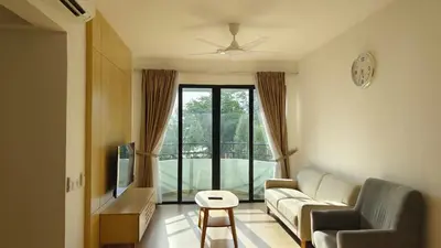 a living room with a couch and a tv at Seaview mutiara melaka Pantai puteri in Gua Sai