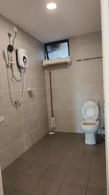 a bathroom with a shower and a toilet at Seaview mutiara melaka Pantai puteri in Gua Sai