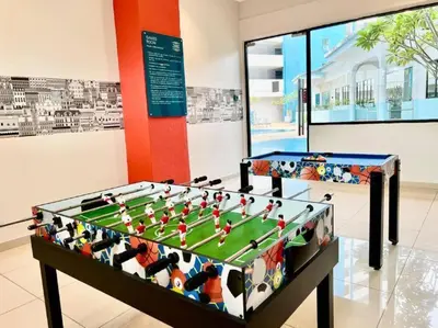 two foosball tables in a room with at Seaview mutiara melaka Pantai puteri in Gua Sai