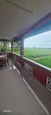 a train station with a view of a green field at Fauziah Sungai Besar Homestay in Sungai Besar