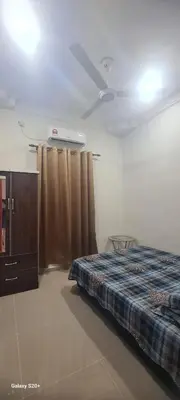a bedroom with a bed and a dresser and curtains at Fauziah Sungai Besar Homestay in Sungai Besar
