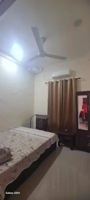 a bedroom with a bed and a ceiling fan at Fauziah Sungai Besar Homestay in Sungai Besar