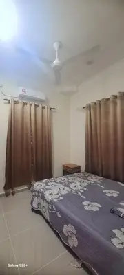 a bedroom with a bed and curtains in a room at Fauziah Sungai Besar Homestay in Sungai Besar