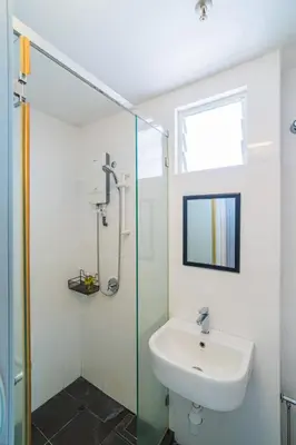 a bathroom with a sink and a glass shower at 2BR Maritime Suite Duplex George Town SeaView in George Town