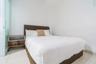 a bedroom with a large white bed with a night stand at 2BR Maritime Suite Duplex George Town SeaView in George Town